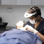 Dermatologist treating a patient